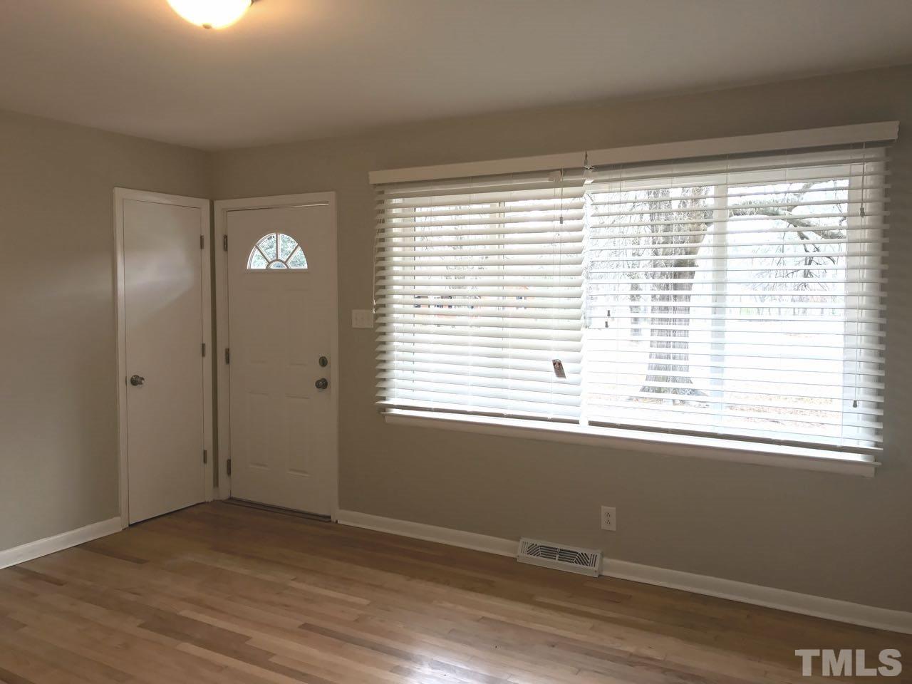 111 Barclay Road Durham, NC 27712 - Photo 9 of 21 a view of an empty room with wooden floor and a window