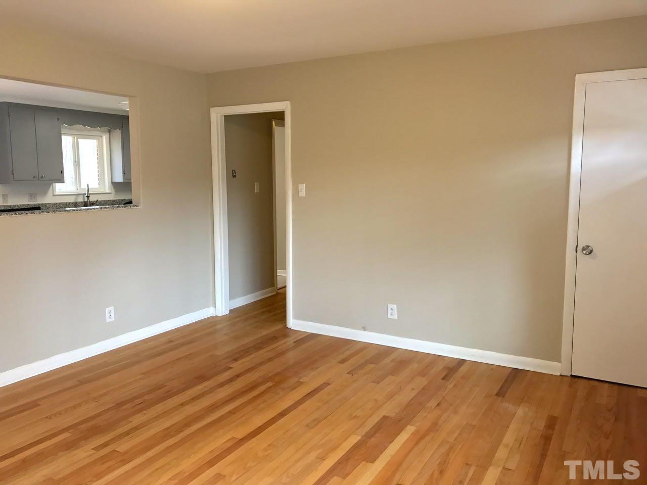 111 Barclay Road Durham, NC 27712 - Photo 10 of 21 an empty room with wooden floor and windows