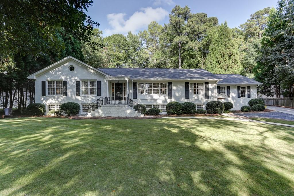 4415 Wieuca Road Northeast Atlanta, GA 30342 - Photo 1 of 1 a front view of a house with a yard table and chairs