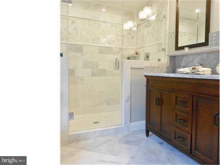 504 Conshohocken State Road Gladwyne, PA 19035 - Photo 16 of 19 a bathroom with a sink a shower and a mirror
