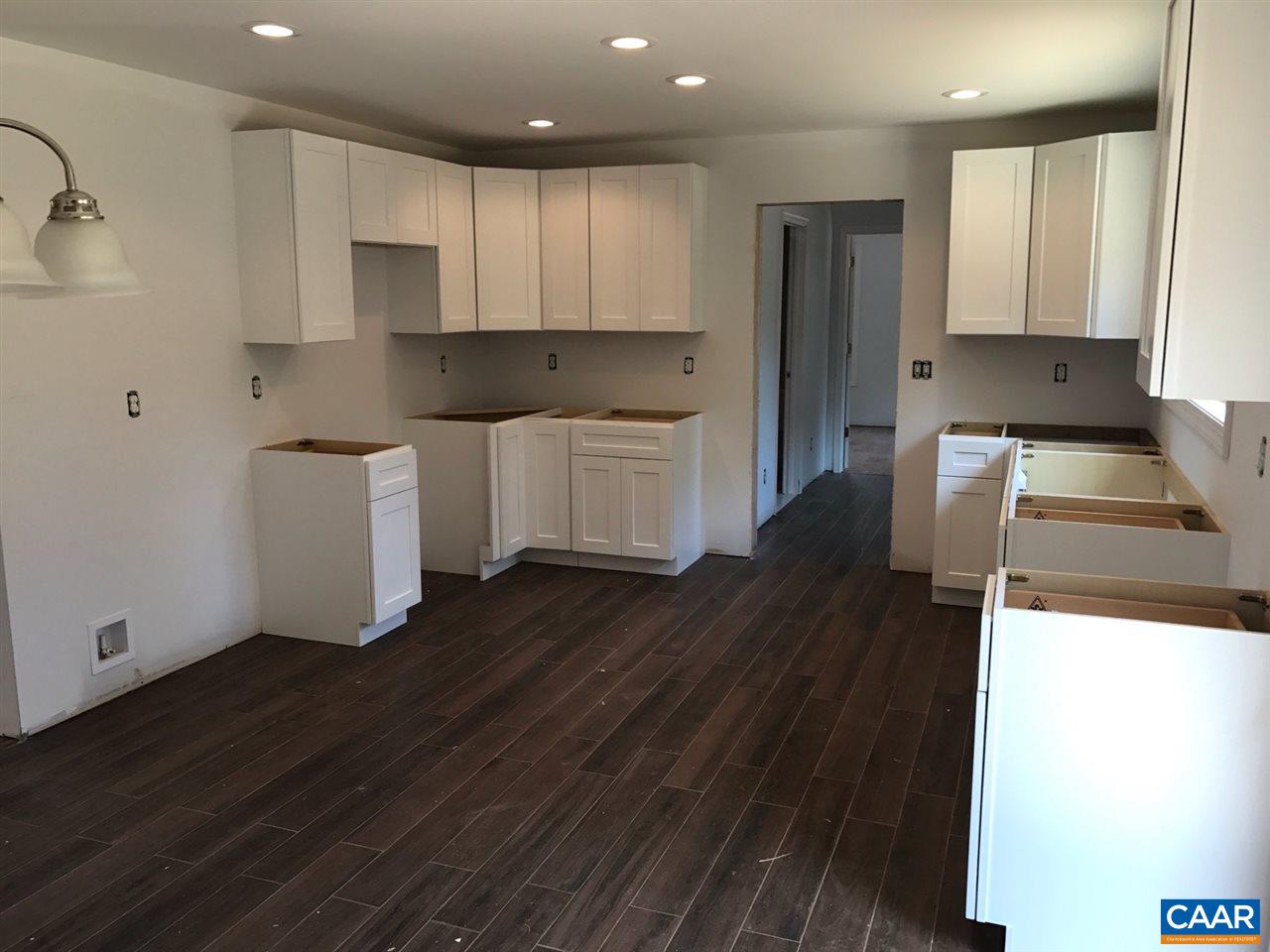 69 Dandelion Road Ruckersville, VA 22968 - Photo 6 of 10 a kitchen with a refrigerator and white cabinets