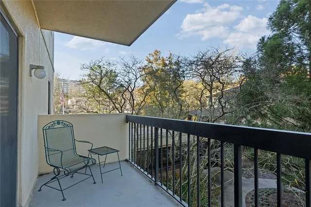 a view of a balcony with furniture and a gate