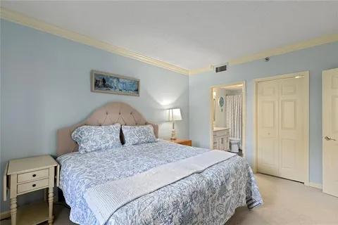 a bedroom with a large bed and a lamp