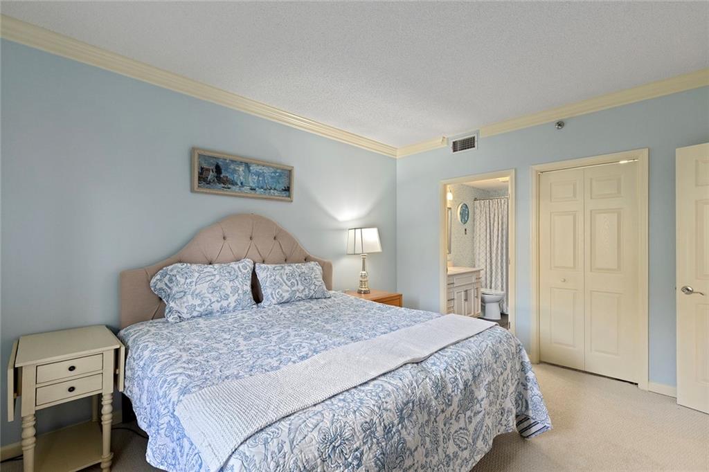 1800 Clairmont Lake, Unit A209 Decatur, GA 30033 - Photo 17 of 35 a bedroom with a large bed and a lamp