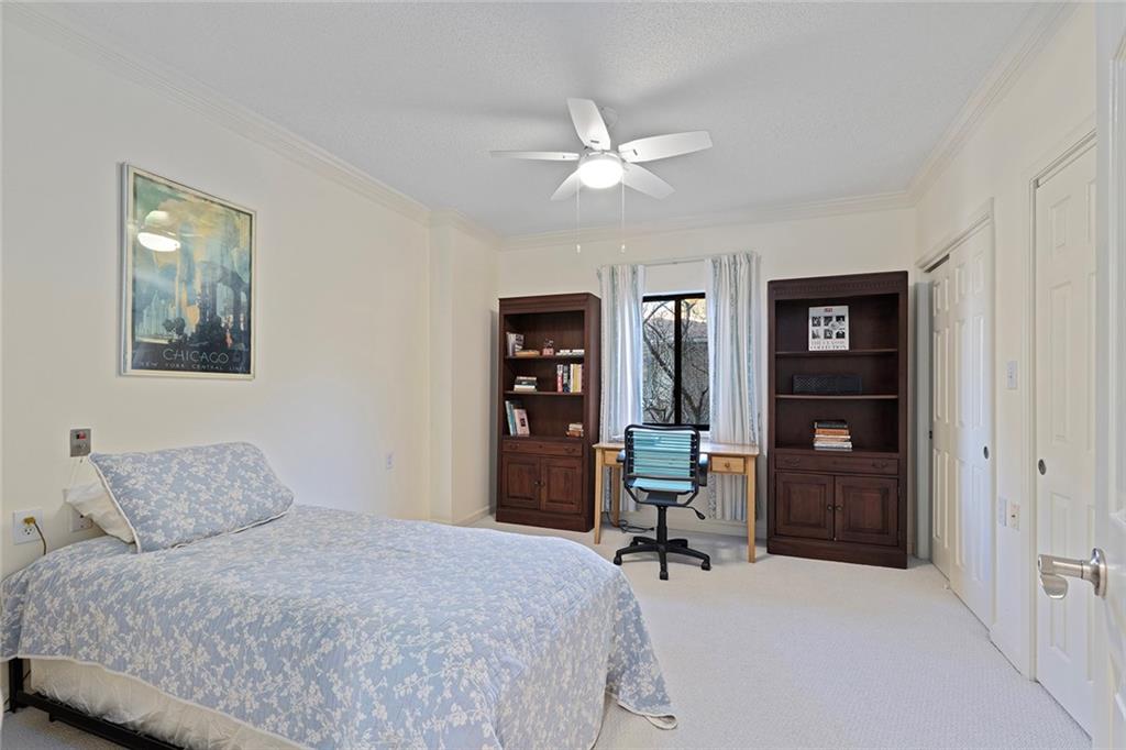 1800 Clairmont Lake, Unit A209 Decatur, GA 30033 - Photo 20 of 35 a bedroom with a bed and a chandelier