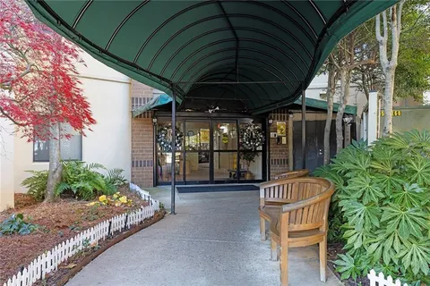 a patio with a table and chairs and potted plants