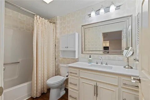 a bathroom with a sink toilet and shower