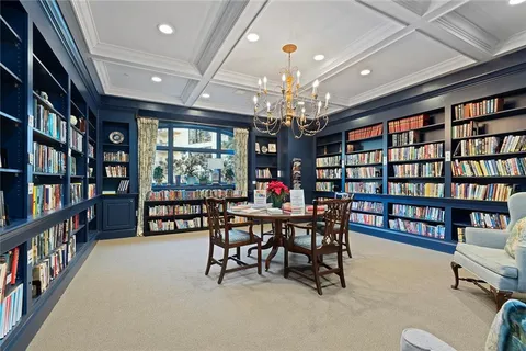 a view of a dining room with furniture a book shelves and a book shelf