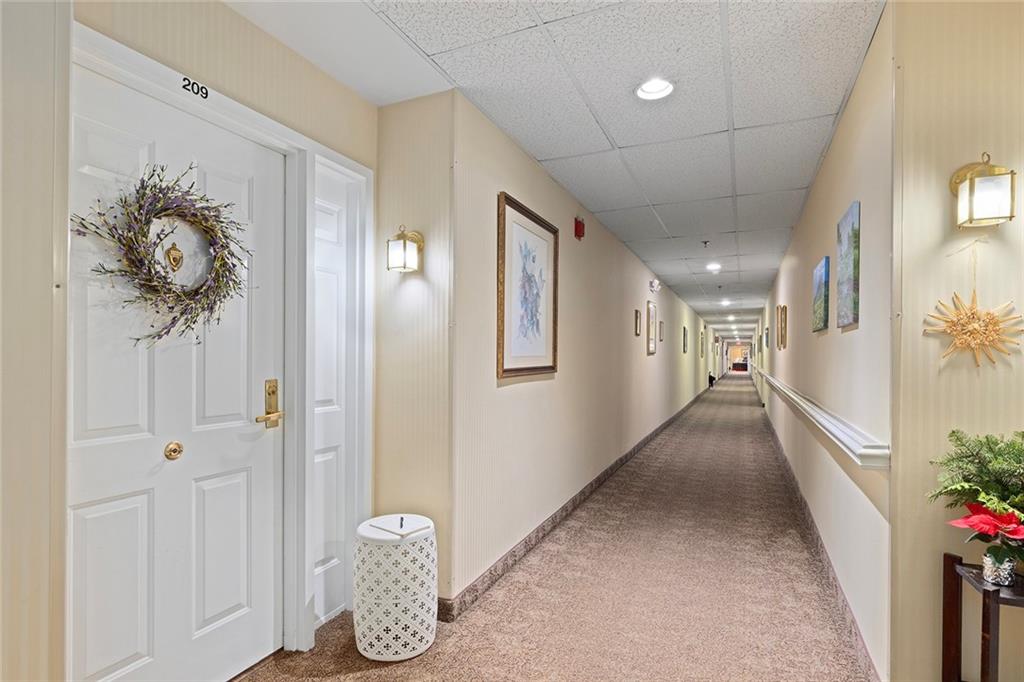 1800 Clairmont Lake, Unit A209 Decatur, GA 30033 - Photo 3 of 35 a hallway with wooden floor and entryway
