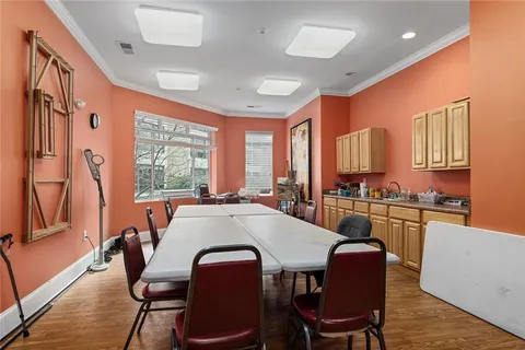 a kitchen with stainless steel appliances granite countertop a stove a kitchen island a table and chairs