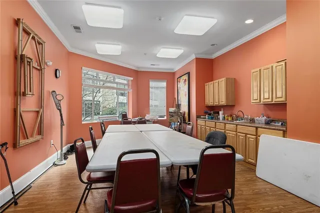 a kitchen with stainless steel appliances granite countertop a stove a kitchen island a table and chairs