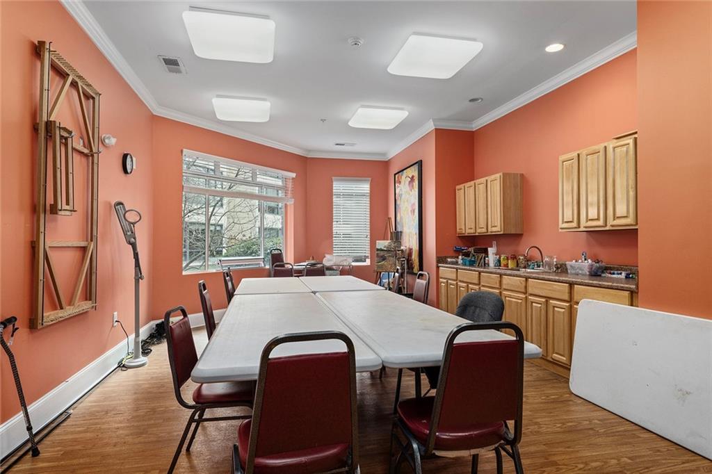 1800 Clairmont Lake, Unit A209 Decatur, GA 30033 - Photo 32 of 35 a kitchen with stainless steel appliances granite countertop a stove a kitchen island a table and chairs