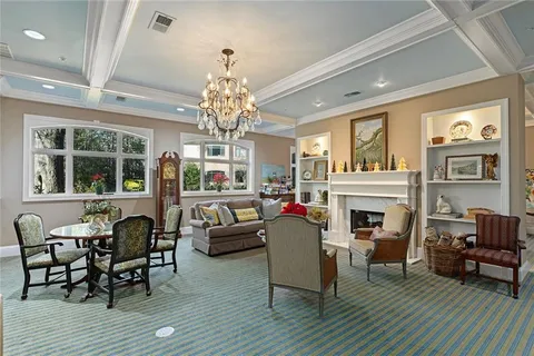 a living room with furniture dining table and a fireplace