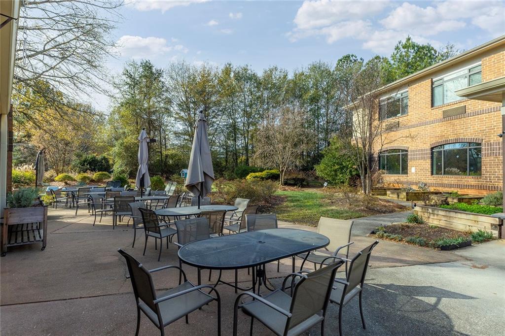 1800 Clairmont Lake, Unit A209 Decatur, GA 30033 - Photo 35 of 35 a view of a patio with table and chairs and potted plants