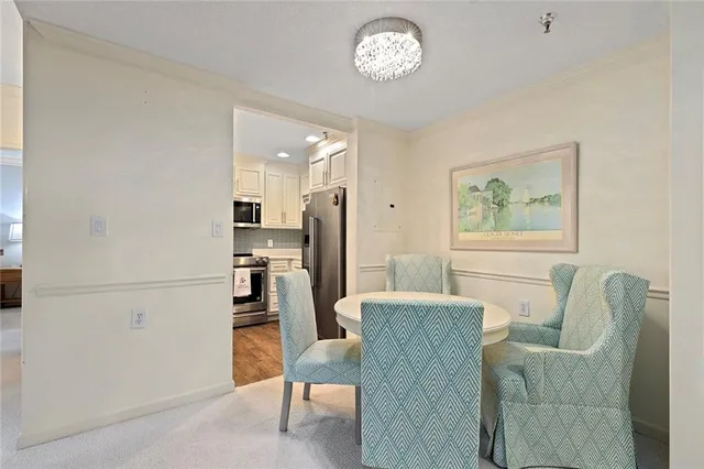 a living room with furniture a refrigerator and a dining table