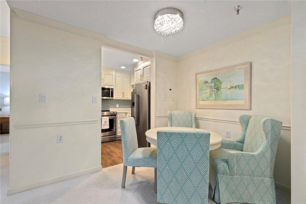 1800 Clairmont Lake, Unit A209 Decatur, GA 30033 - Photo 7 of 35 a living room with furniture a refrigerator and a dining table