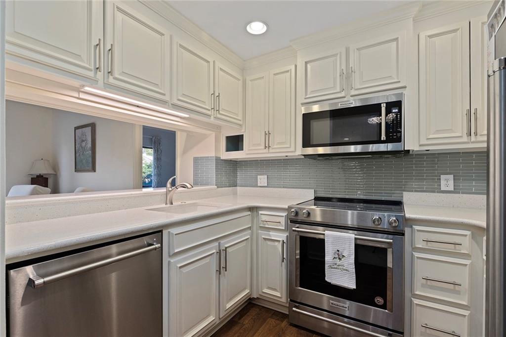 1800 Clairmont Lake, Unit A209 Decatur, GA 30033 - Photo 9 of 35 a kitchen with cabinets stainless steel appliances and white cabinets