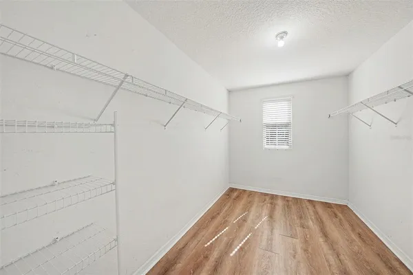 a view of a room with wooden floor