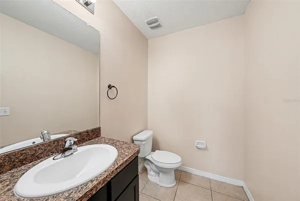 a bathroom with a sink a toilet and mirror
