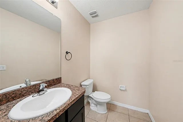 a bathroom with a sink a toilet and mirror