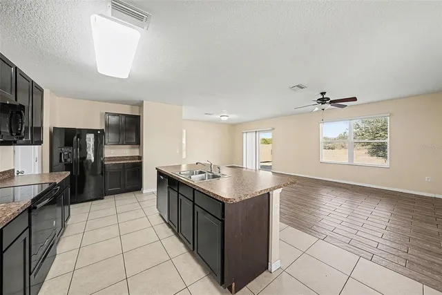 a kitchen with stainless steel appliances granite countertop a refrigerator and a stove