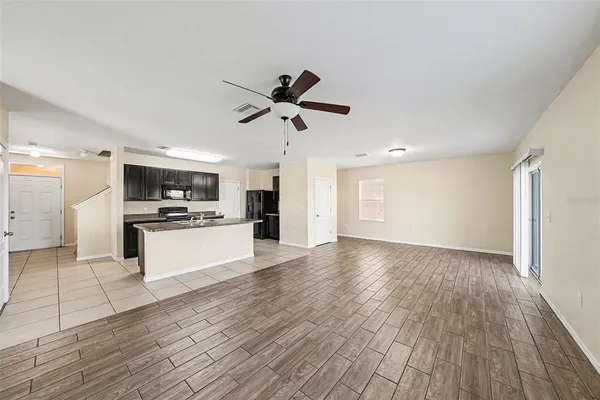 a view of kitchen with cabinets appliances and wooden floor