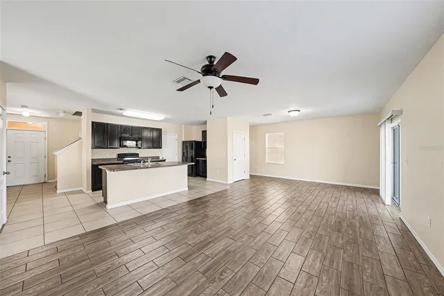 a view of kitchen with cabinets appliances and wooden floor