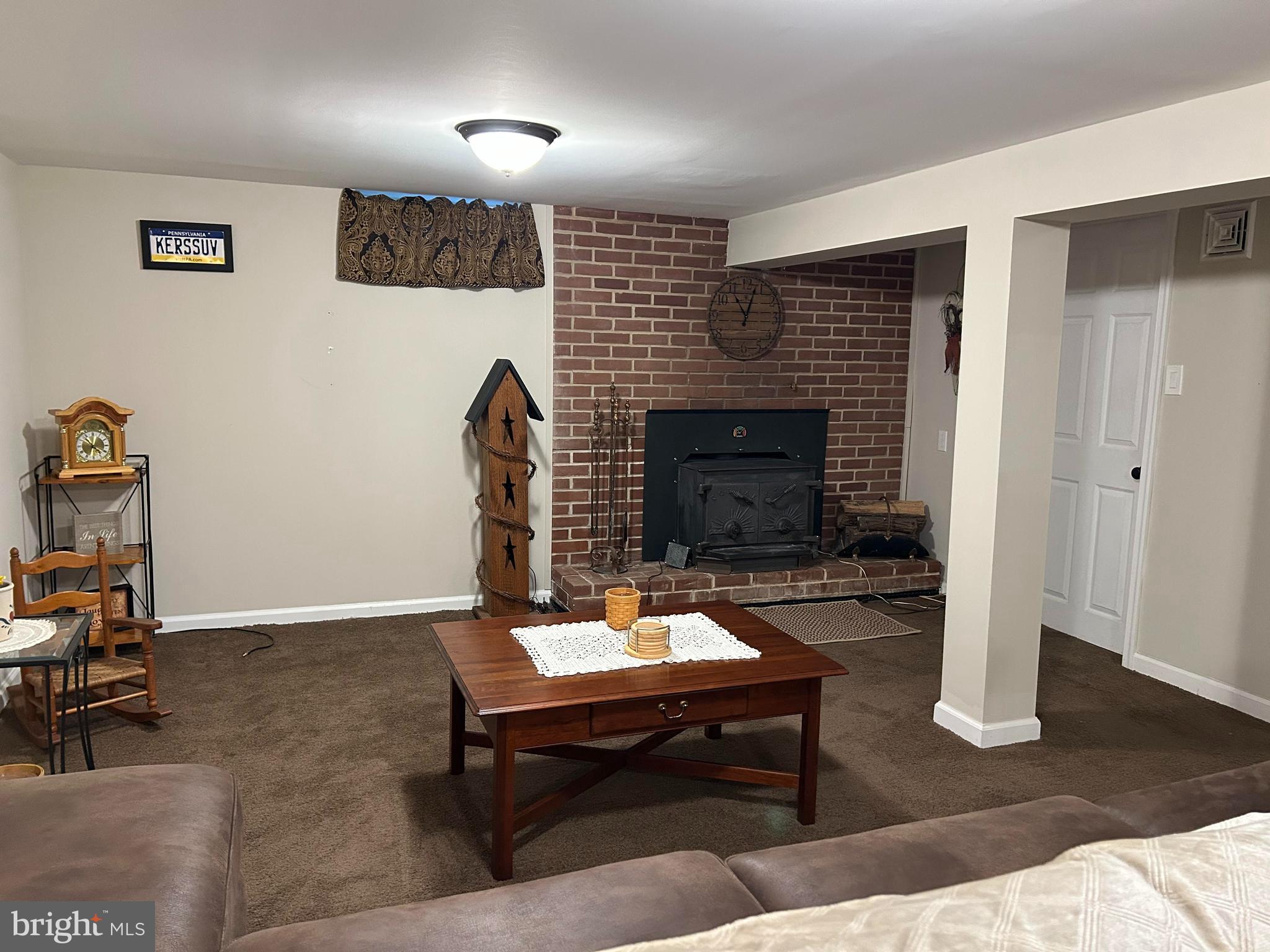 259 Hoffman Road Gettysburg, PA 17325 - Photo 20 of 23 a living room with furniture a fireplace and a flat screen tv
