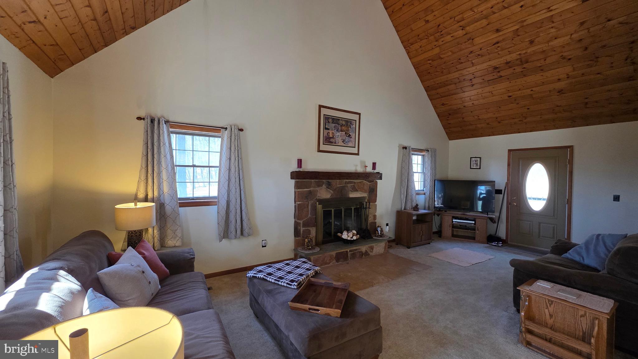 3027 Whitesel Road James Creek, PA 16657 - Photo 7 of 51 a living room with furniture mirror and a fireplace