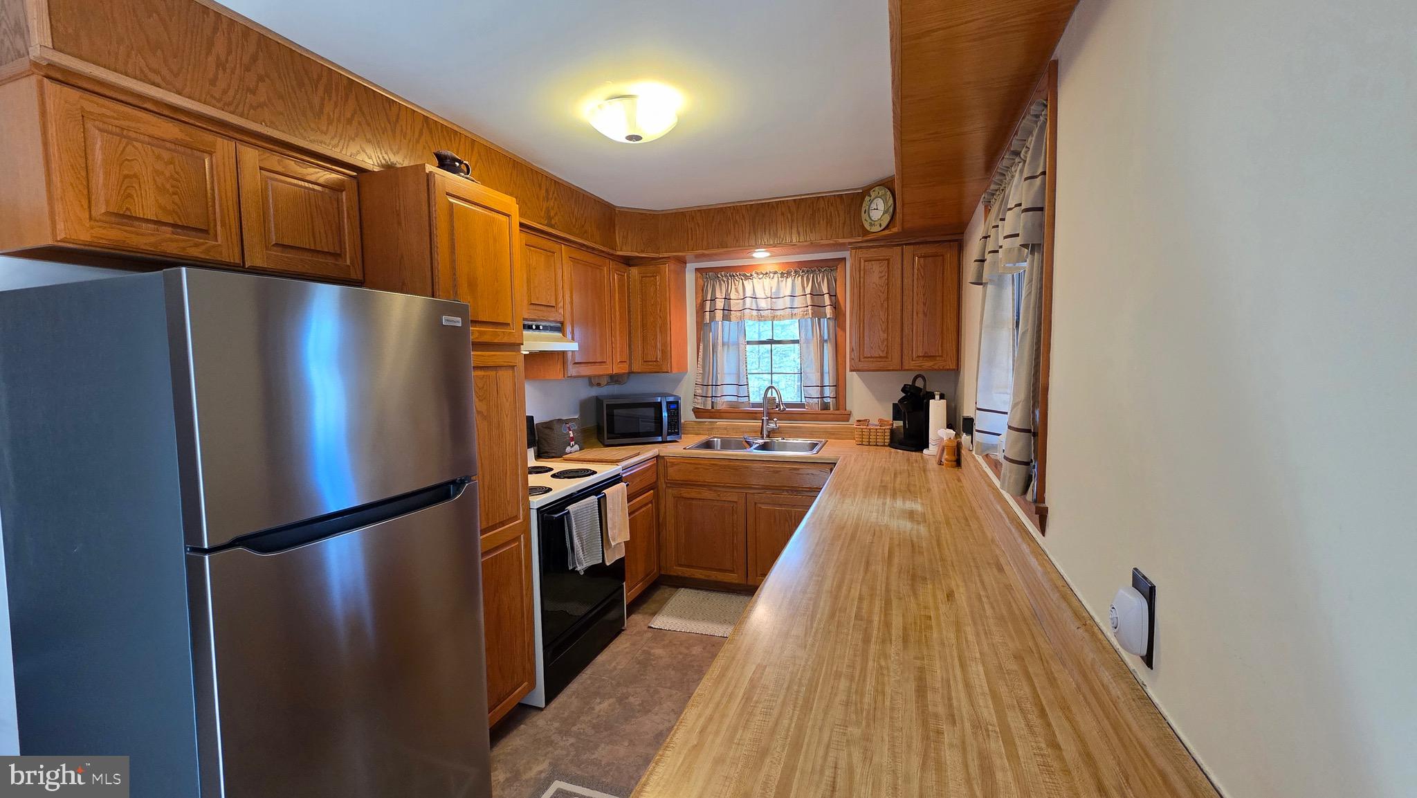 3027 Whitesel Road James Creek, PA 16657 - Photo 9 of 51 a kitchen with stainless steel appliances granite countertop a refrigerator a stove and a sink