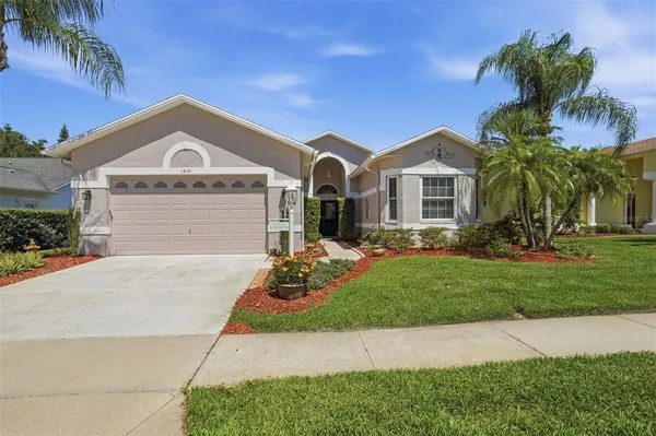 a front view of a house with a yard and garage