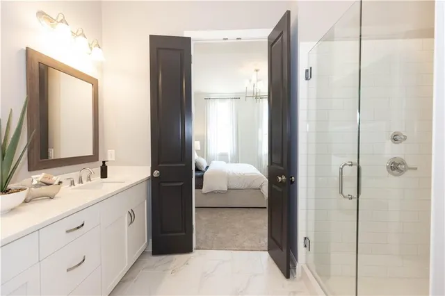 a bathroom with a sink and a mirror with toilet