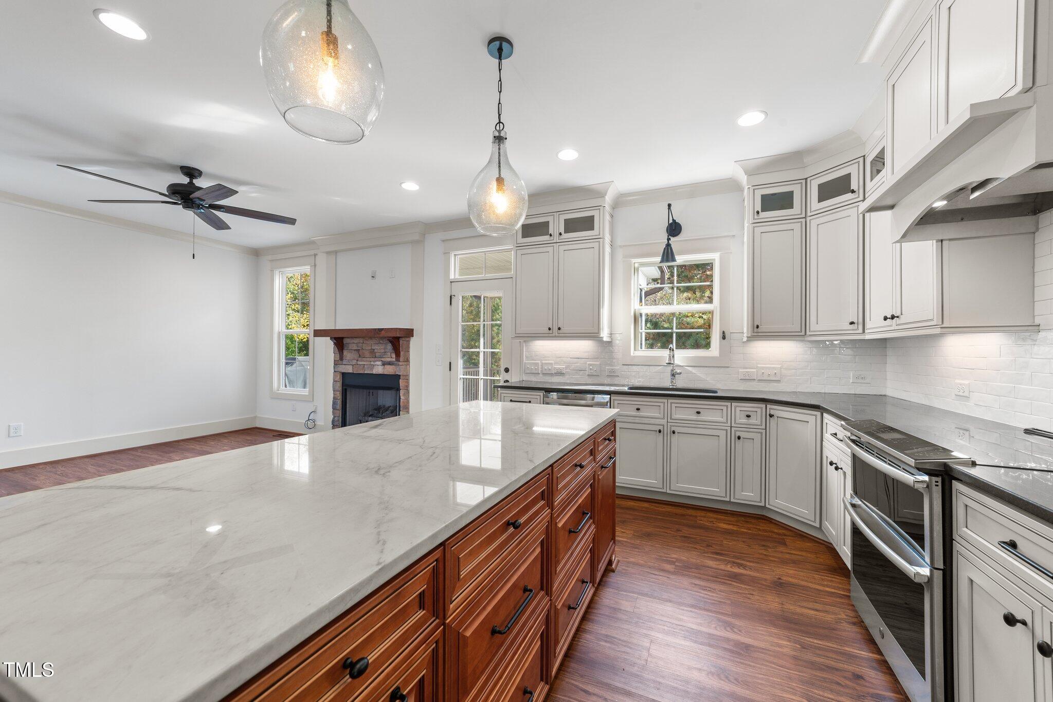 3820 Benson Hardee Road Benson, NC 27504 - Photo 11 of 55 a large kitchen with granite countertop a large center island a sink stainless steel appliances and cabinets