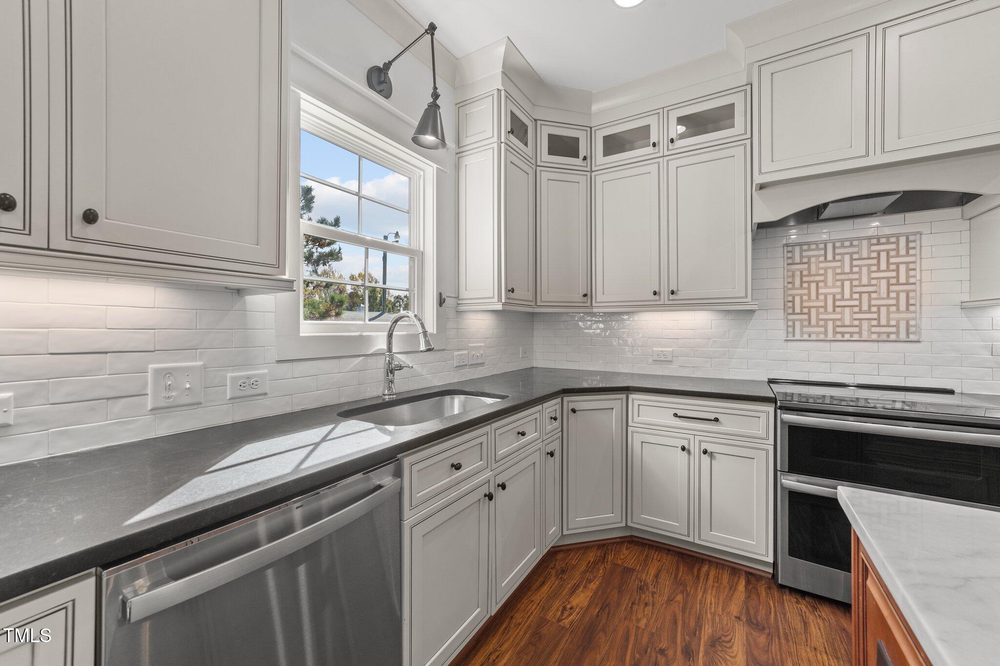 3820 Benson Hardee Road Benson, NC 27504 - Photo 12 of 55 a kitchen with a sink cabinets stainless steel appliances and a window