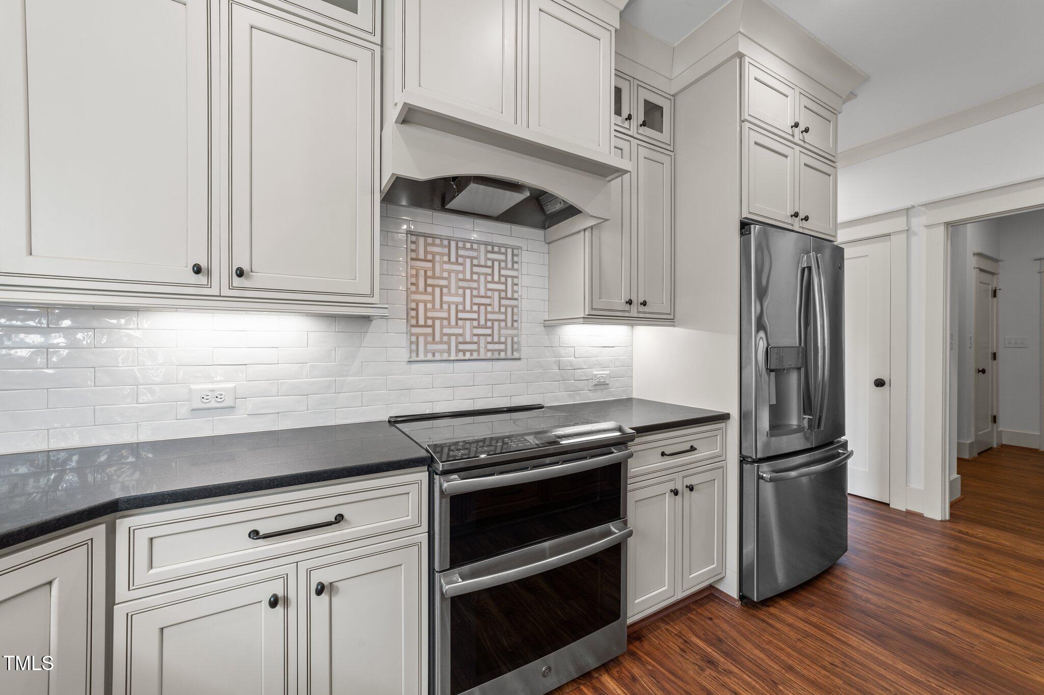 3820 Benson Hardee Road Benson, NC 27504 - Photo 13 of 55 a kitchen with granite countertop a refrigerator and a stove top oven