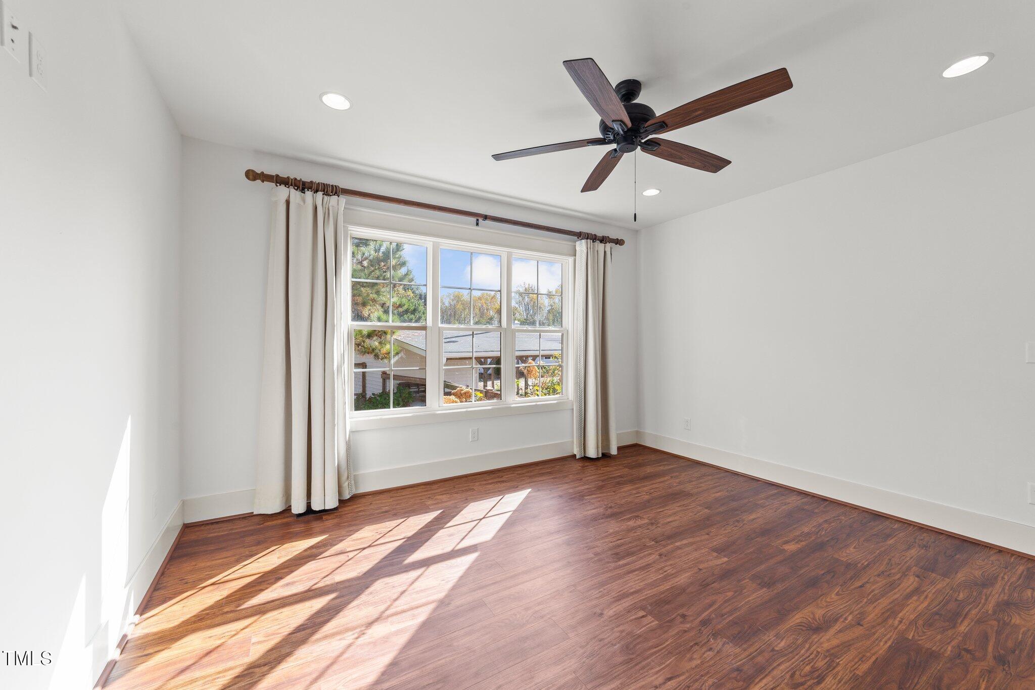 3820 Benson Hardee Road Benson, NC 27504 - Photo 14 of 55 a view of an empty room with wooden floor and a window