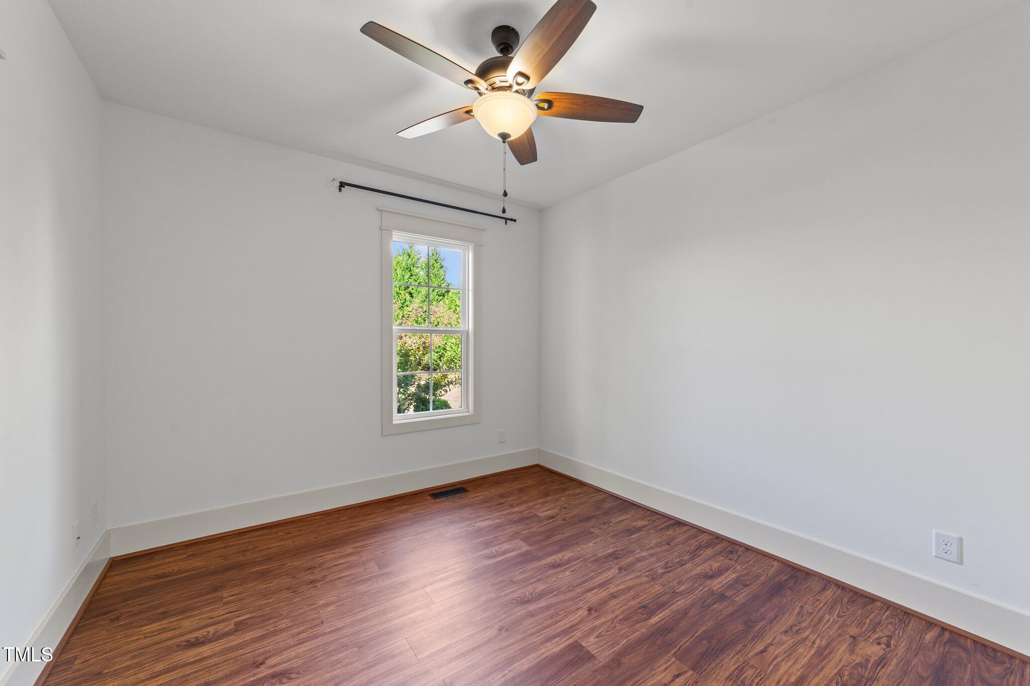 3820 Benson Hardee Road Benson, NC 27504 - Photo 21 of 55 a view of an empty room with window and wooden floor