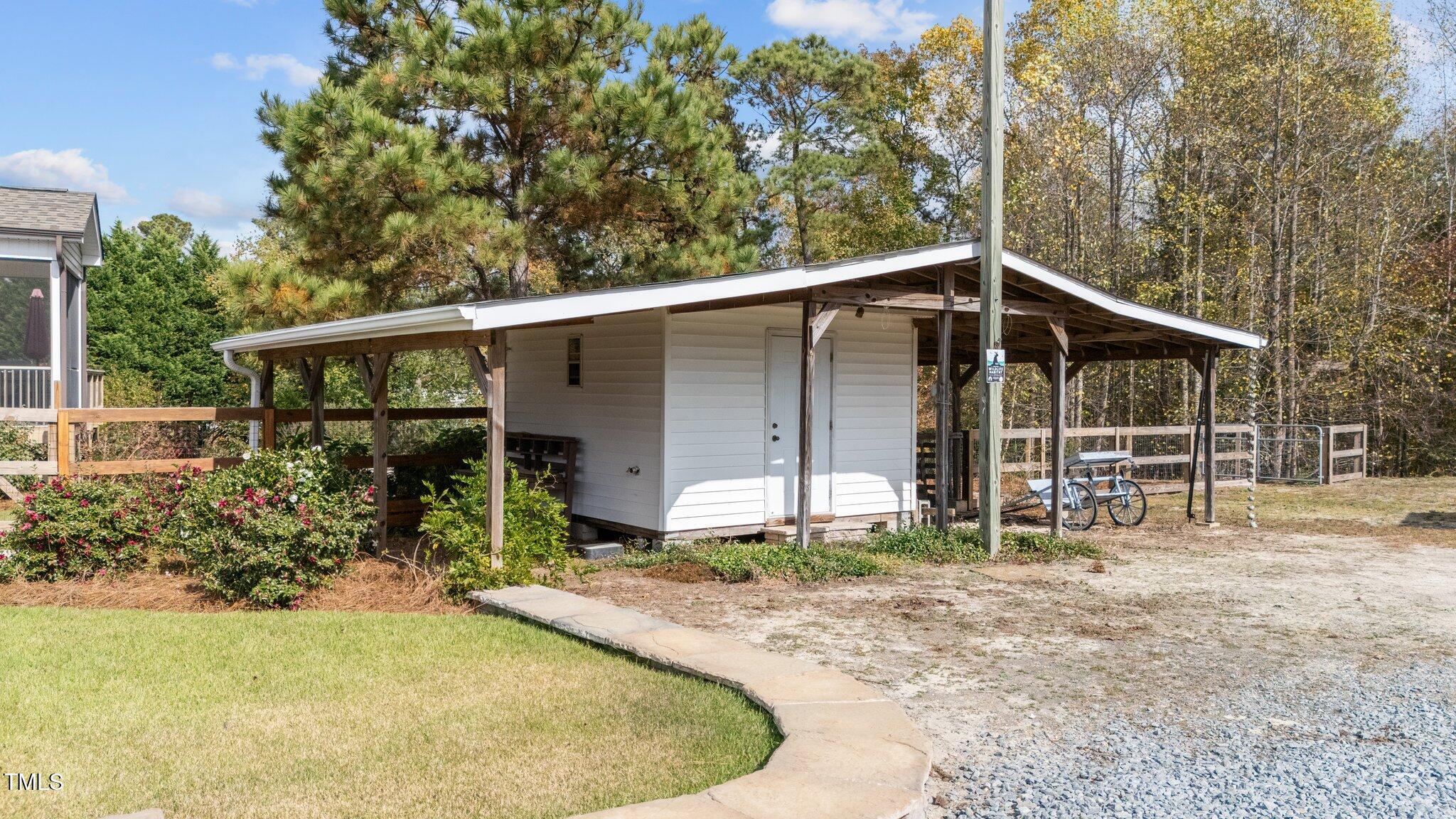 3820 Benson Hardee Road Benson, NC 27504 - Photo 34 of 55 a view of backyard with small cabin