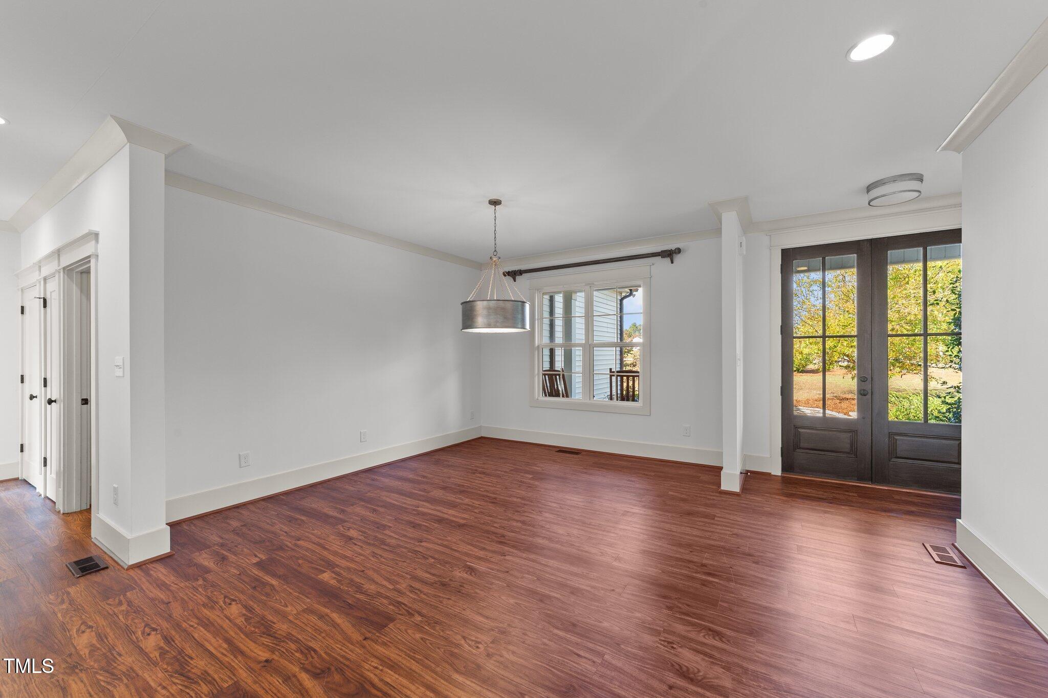 3820 Benson Hardee Road Benson, NC 27504 - Photo 5 of 55 an empty room with wooden floor and windows