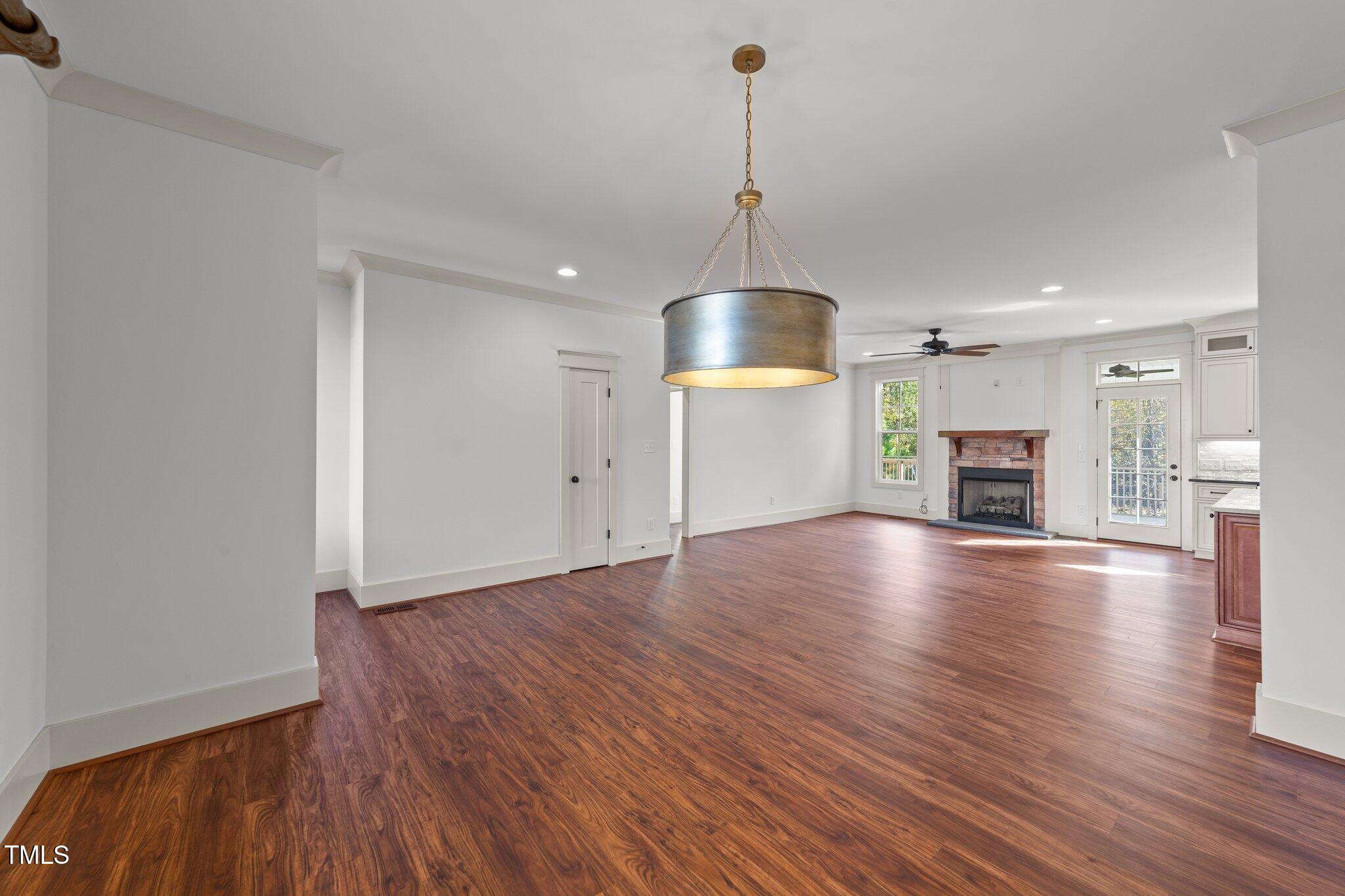 3820 Benson Hardee Road Benson, NC 27504 - Photo 6 of 55 a view of empty room with wooden floor and fireplace