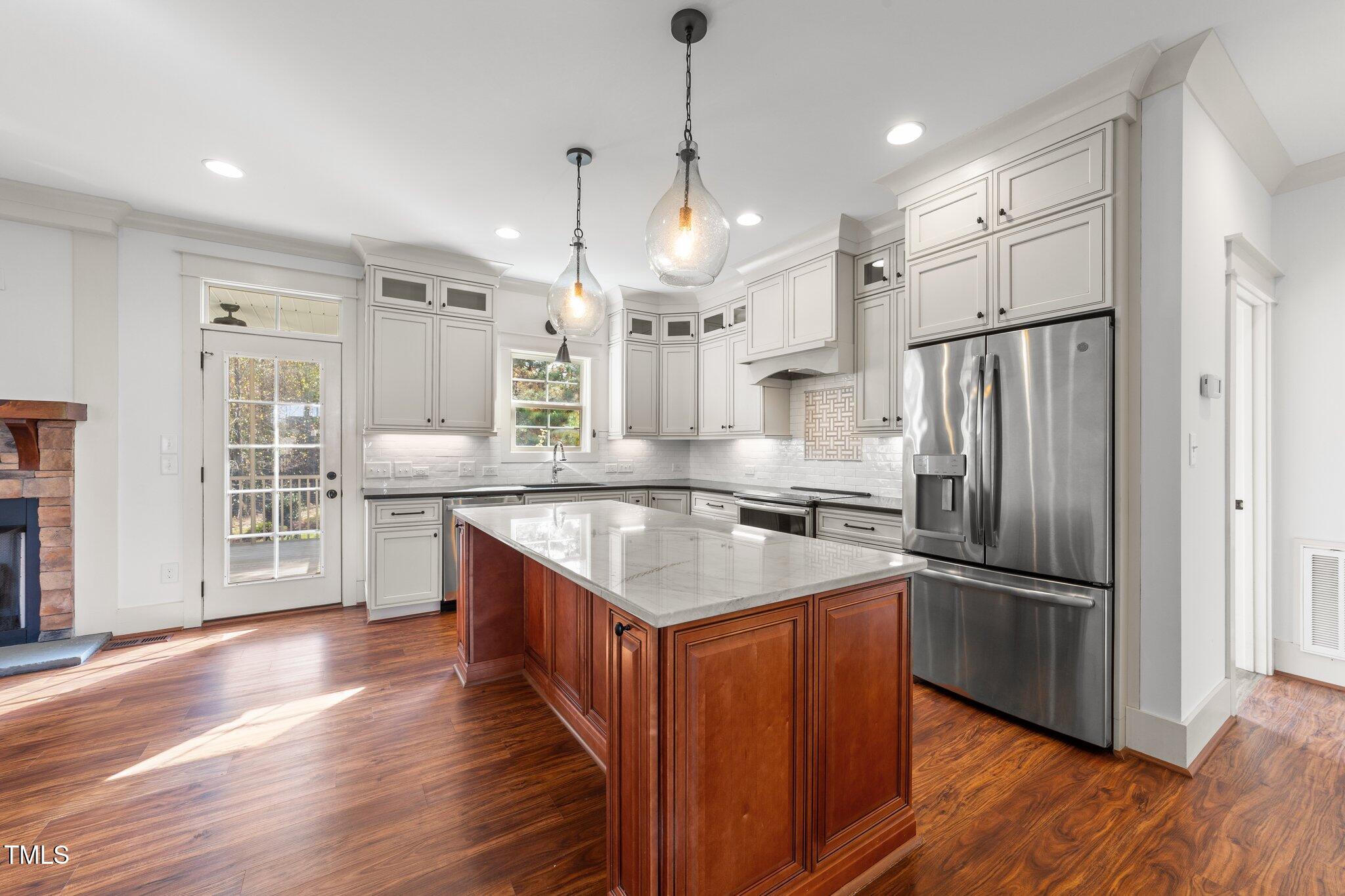 3820 Benson Hardee Road Benson, NC 27504 - Photo 9 of 55 a kitchen with stainless steel appliances granite countertop a refrigerator a sink dishwasher a oven and a dining table with wooden floor