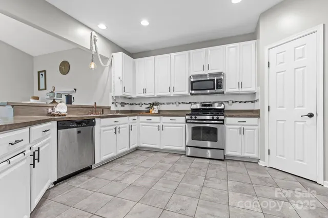 a kitchen with a stove sink and cabinets