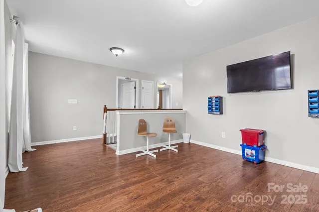 a view of a livingroom with furniture and a flat screen tv