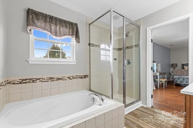 a bathroom with a bathtub and a shower