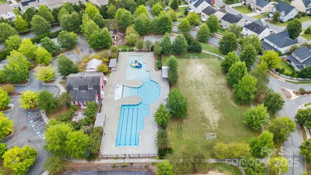 an aerial view of a house with a yard and garden