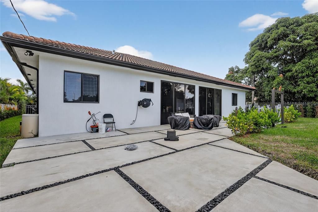 11405 East Golf Drive Miami, FL 33167 - Photo 11 of 25 a view of the house with backyard and sitting area