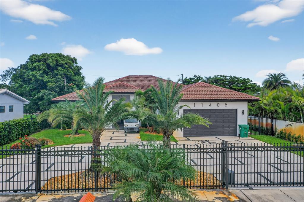 11405 East Golf Drive Miami, FL 33167 - Photo 12 of 25 a front view of a house with a garden