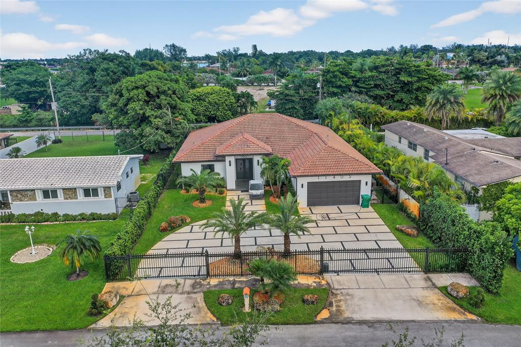 11405 East Golf Drive Miami, FL 33167 - Photo 13 of 25 a front view of a house with garden
