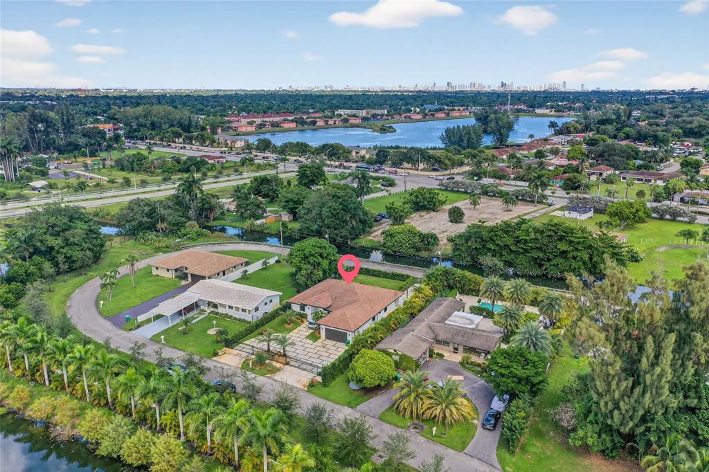 11405 East Golf Drive Miami, FL 33167 - Photo 17 of 25 an aerial view of a city with lots of residential buildings ocean and mountain view in back