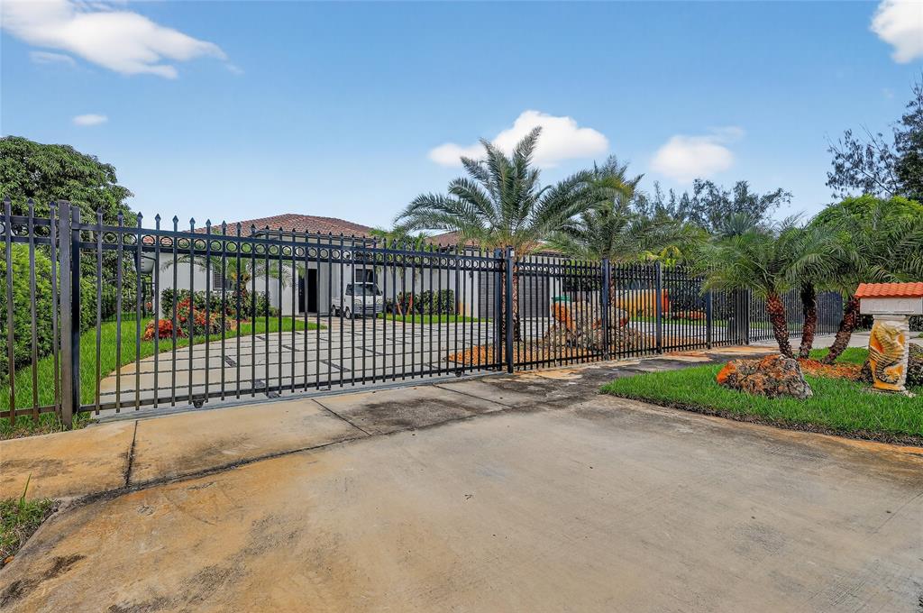 11405 East Golf Drive Miami, FL 33167 - Photo 5 of 25 a view of street along with wooden fence
